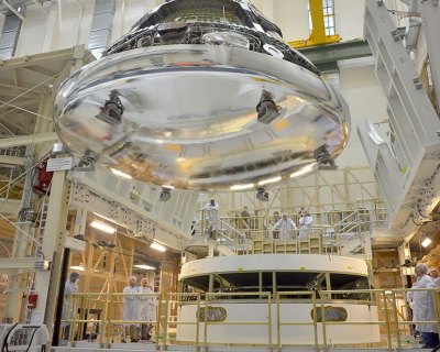Scientists work on the Orion crew module for Exploration Flight Test-1. Image: Rad Sinyak, NASA.
